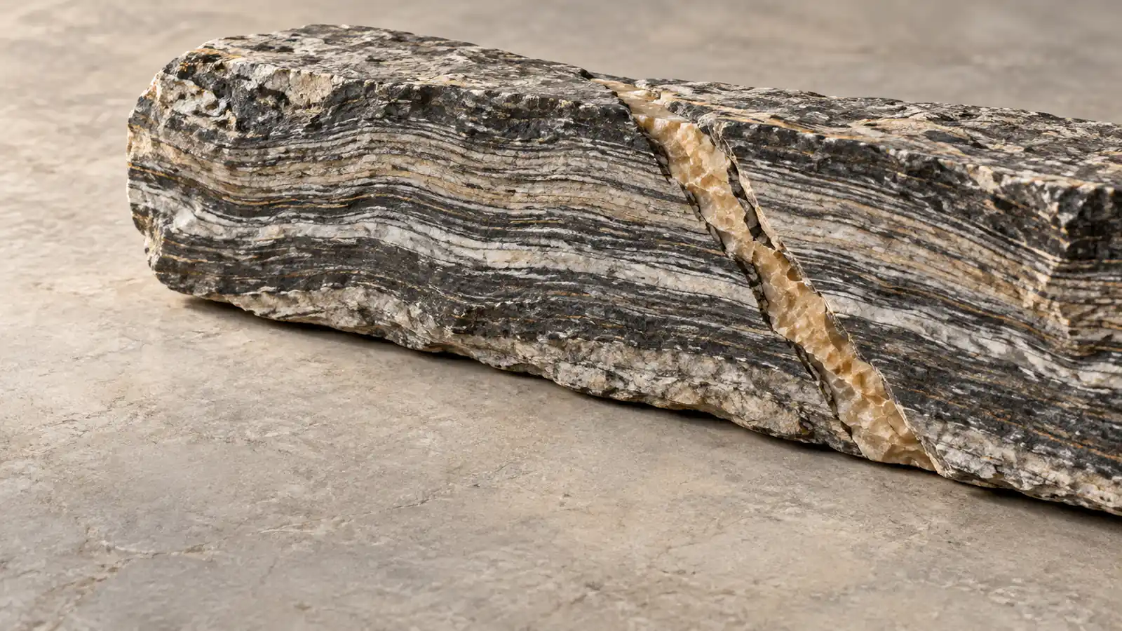 Illustrative banded stone cross-section with one fault line crossing an ordered sequence of layers